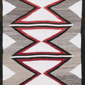 Geometric rug runner with white, red, black, and heathered gray hourglass and zigzag designs.