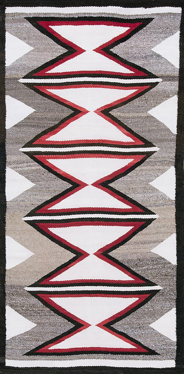 Geometric rug runner with white, red, black, and heathered gray hourglass and zigzag designs.