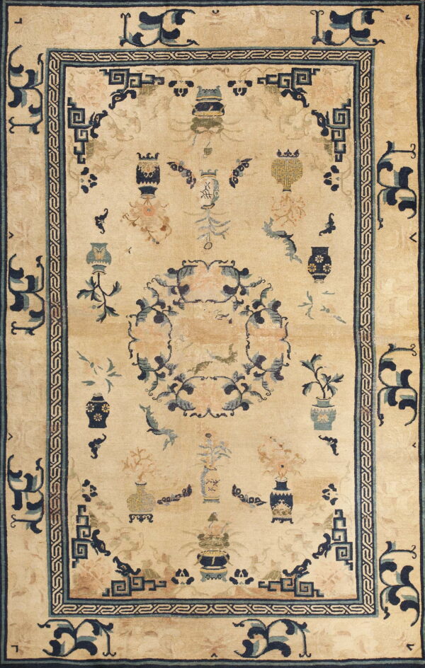 Light beige rug patterned with vases and a central floral wreath in blue and peach accents.