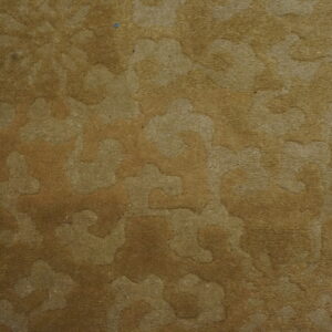 Sculpted medium pile rug featuring a tone-on-tone abstract pattern in shades of brown and tan.