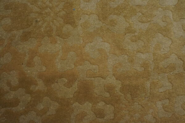 Sculpted medium pile rug featuring a tone-on-tone abstract pattern in shades of brown and tan.