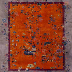 Orange rug with multicolor floral vines, an inner burgundy border, and a wide dusty gray outer border.