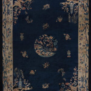 Deep blue rug with a central medallion and florals, framed by an intricate beige landscape border.