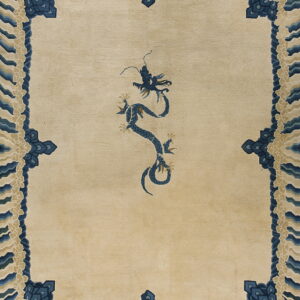 Beige low-pile rug with a detailed blue dragon pattern and blue and cream wave borders.