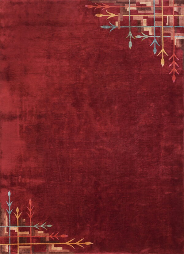 A solid red, plush rug features geometric and stylized leaf patterns in the top-right and bottom-left corners.
