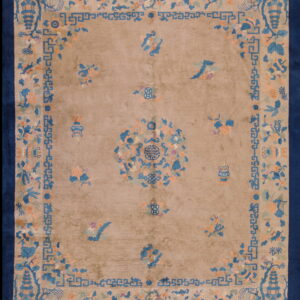 Tan rug with a navy border featuring blue, peach, and green Asian floral and geometric designs.