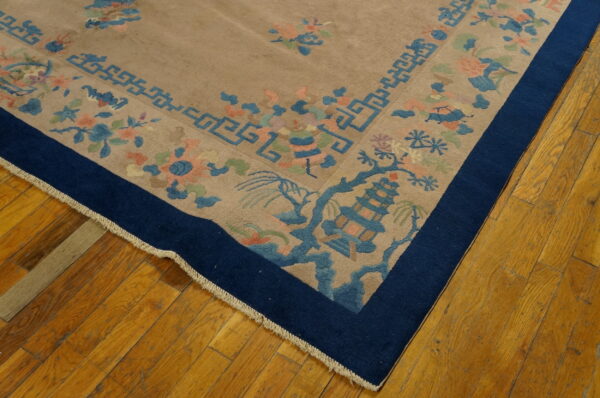 A beige rug corner displays blue pagoda, geometric fretwork, and soft floral patterns on hardwood flooring.
