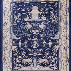 Deep blue rug with an intricate cream and light blue pictorial pattern of figures, birds, pagodas, and flowering vines.