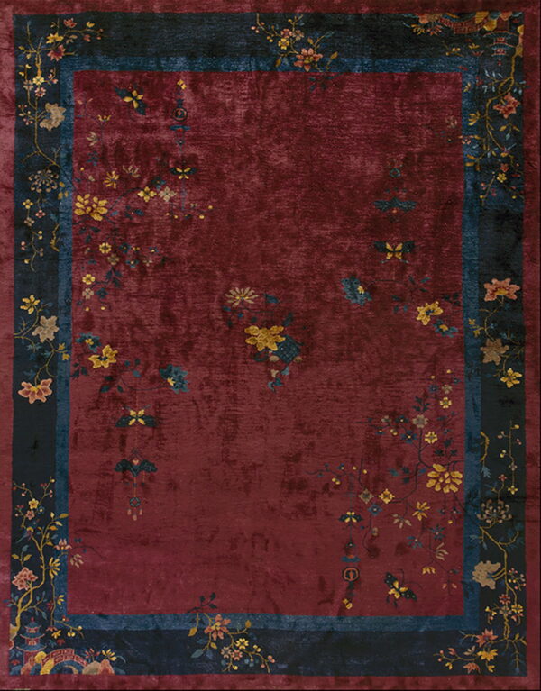 Low-pile, distressed burgundy rug featuring delicate yellow floral sprays and a wide dark navy pictorial border.