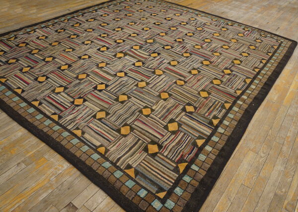 Multi-colored striped rug with a basketweave design and yellow accents lying on light wood planks.