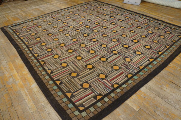 Textured rug with a striped basketweave pattern, yellow accents, and a checked border on distressed wood floor.