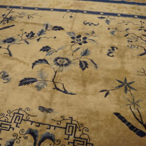 Beige rug featuring sprawling blue trees, flowers, and bamboo motifs with a detailed dark blue border.
