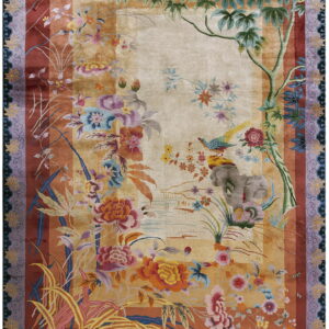 Beige and rust colored rug featuring dense, vibrant floral patterns, a yellow bird, and wide purple borders.