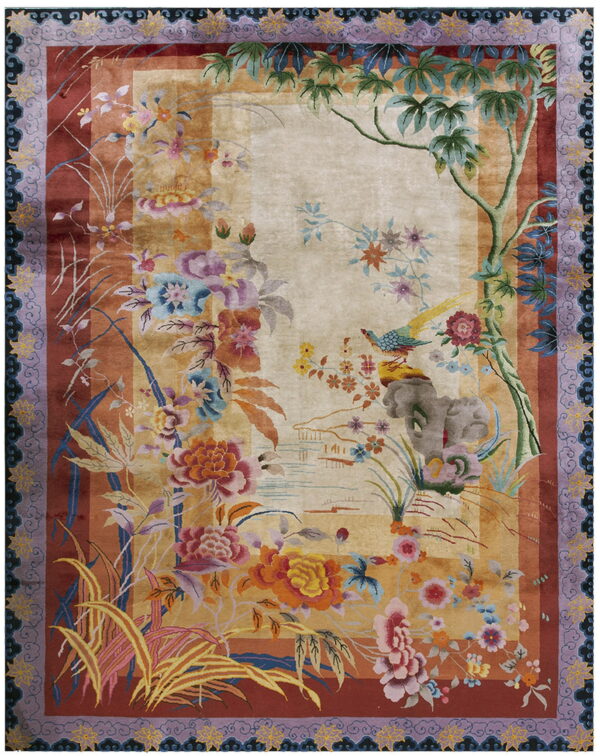 Beige and rust colored rug featuring dense, vibrant floral patterns, a yellow bird, and wide purple borders.
