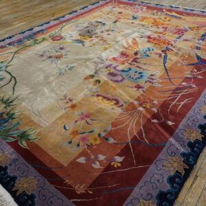 High pile rug displays a vibrant floral and botanical design across diagonal cream, gold, and red fields.