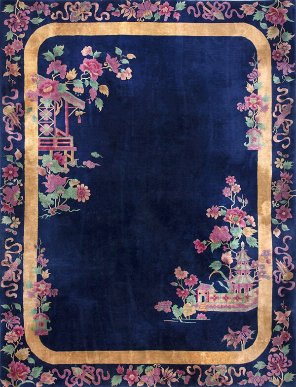 Rectangular dark blue rug with a gold border and pink florals surrounding chinese-style architecture.
