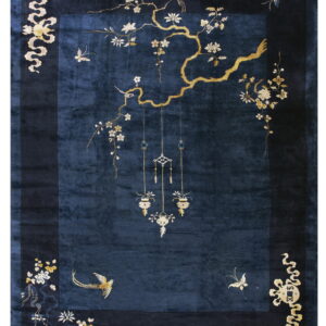 Plush dark blue rug with a wide navy border and elaborate gold botanical and bird motifs.