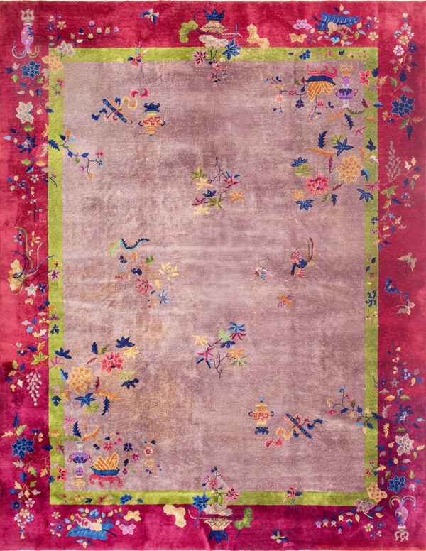 Mauve, magenta, and green rug featuring colorful scattered floral motifs and detailed borders.