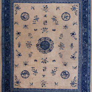 Tan field rug featuring scattered blue floral motifs, a central medallion, and elaborate triple blue borders.