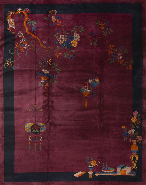 Deep burgundy rug with a dark border featuring multicolored flowering branches and decorative objects.