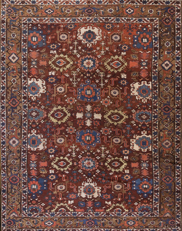 Reddish-brown rug featuring a dense geometric pattern with stylized medallions in blue, cream, and rust.