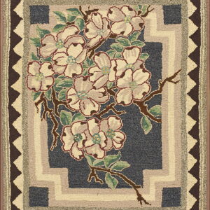 Textured navy rug featuring cream and pink floral motifs framed by complex geometric borders of brown and taupe.