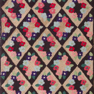 A visually textured hooked rug displaying a lattice of dark and tan diamonds with bright floral designs.