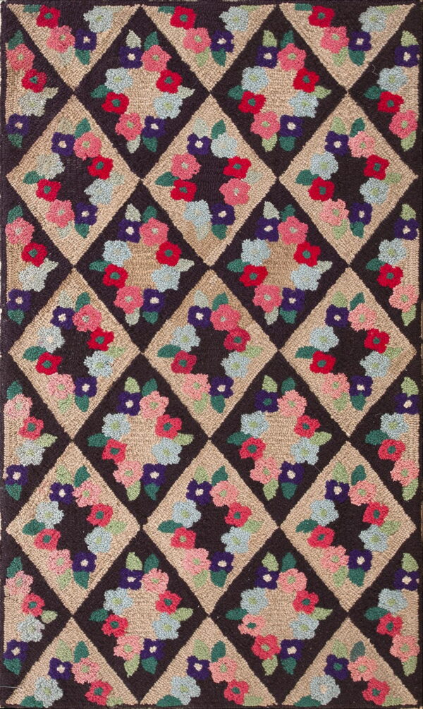 A visually textured hooked rug displaying a lattice of dark and tan diamonds with bright floral designs.
