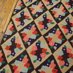 Textured rug runner on wood floor features colorful floral clusters inside dark brown and tan diamonds.