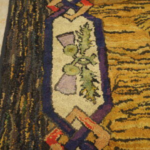 Shaggy, multicolored rug detail featuring yellow stripes and a cream floral border resting on light wooden flooring.