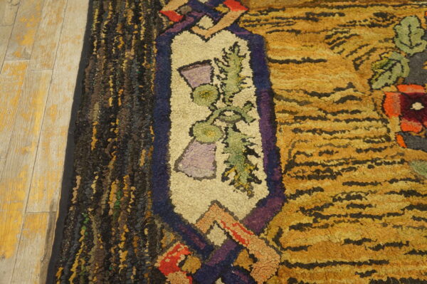 Shaggy, multicolored rug detail featuring yellow stripes and a cream floral border resting on light wooden flooring.