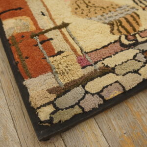 Close-up shows chunky loop pile rug in shades of rust, beige, and gray on distressed wood planks.