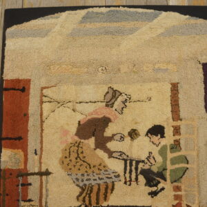 Nubby pile rug with a folk art pattern of a woman and child on rustic, distressed wood flooring.