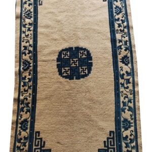 Beige runner rug featuring dark blue borders, a central medallion, and corner geometric patterns.