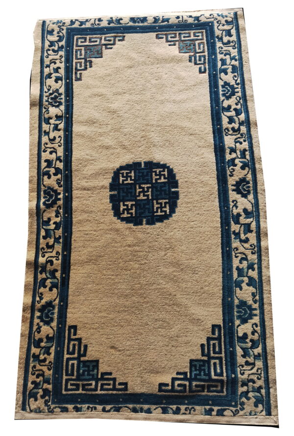 Beige runner rug featuring dark blue borders, a central medallion, and corner geometric patterns.