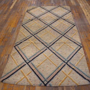 Textured beige runner with geometric diamonds outlined in blue, black, and gold on wood planks.