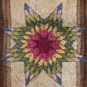 Textured beige rug with a deep pink, green, and yellow star pattern and contrasting brown multi-layered border.