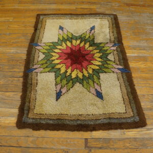 A high-pile rug with a vibrant star medallion and brown borders lies on yellow wooden floors.