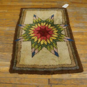Shaggy rug featuring a bright, multicolored starburst pattern against a tan field on a worn wooden floor.