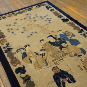 Tan and blue rug depicting people around a table, bordered by blue cloud motifs on wood planks.