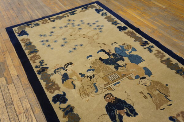 Tan and blue rug depicting people around a table, bordered by blue cloud motifs on wood planks.