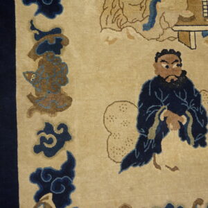 Tan rug detail showing a bearded man in a navy robe next to a dark blue border and wood floor.
