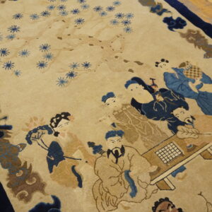 Beige rug with a detailed pictorial pattern featuring blue-robed figures, a game board, and flowering branches.