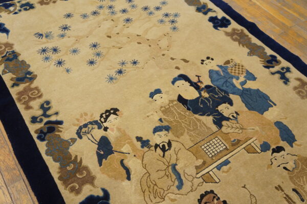 Beige rug with a detailed pictorial pattern featuring blue-robed figures, a game board, and flowering branches.