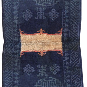 Navy blue rug with gray-blue geometric motifs and a horizontal beige stripe bordered by red.