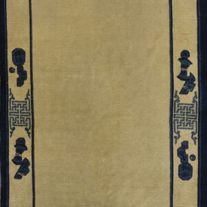 Solid beige field rug framed by an intricate dark blue border with symbols and key patterns.