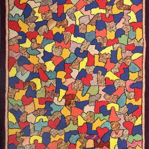 Long runner rug displaying a vivid abstract mosaic pattern of multi-colored solid and mottled shapes.