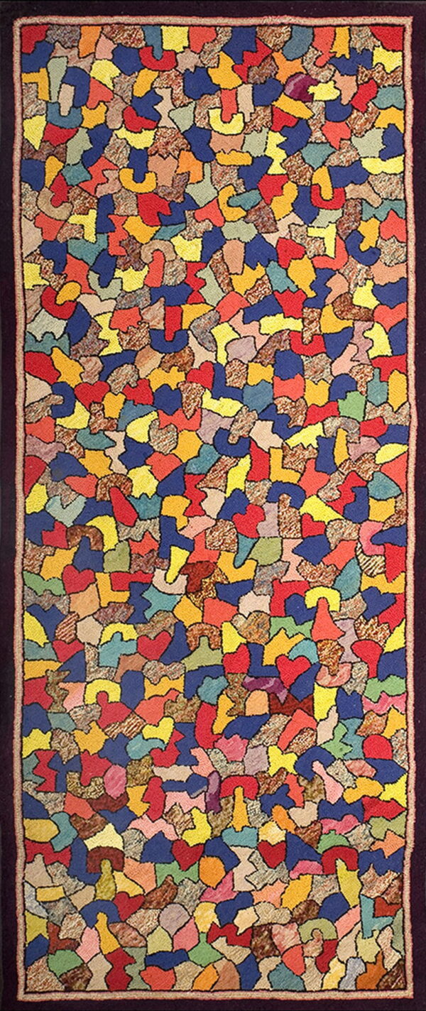 Long runner rug displaying a vivid abstract mosaic pattern of multi-colored solid and mottled shapes.