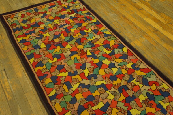 Vibrant runner rug with an abstract mosaic pattern outlined in black, set on warm-toned wood flooring.