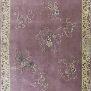 A mauve rug with a cream border featuring scrolling floral and bird patterns.